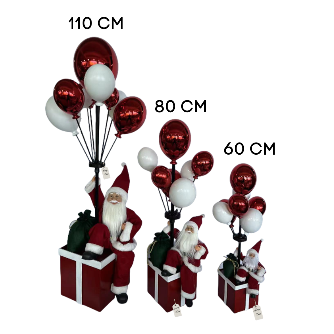 Santa Sitting on Gift Box with Balloons – Christmas Decoration Luxury Casa